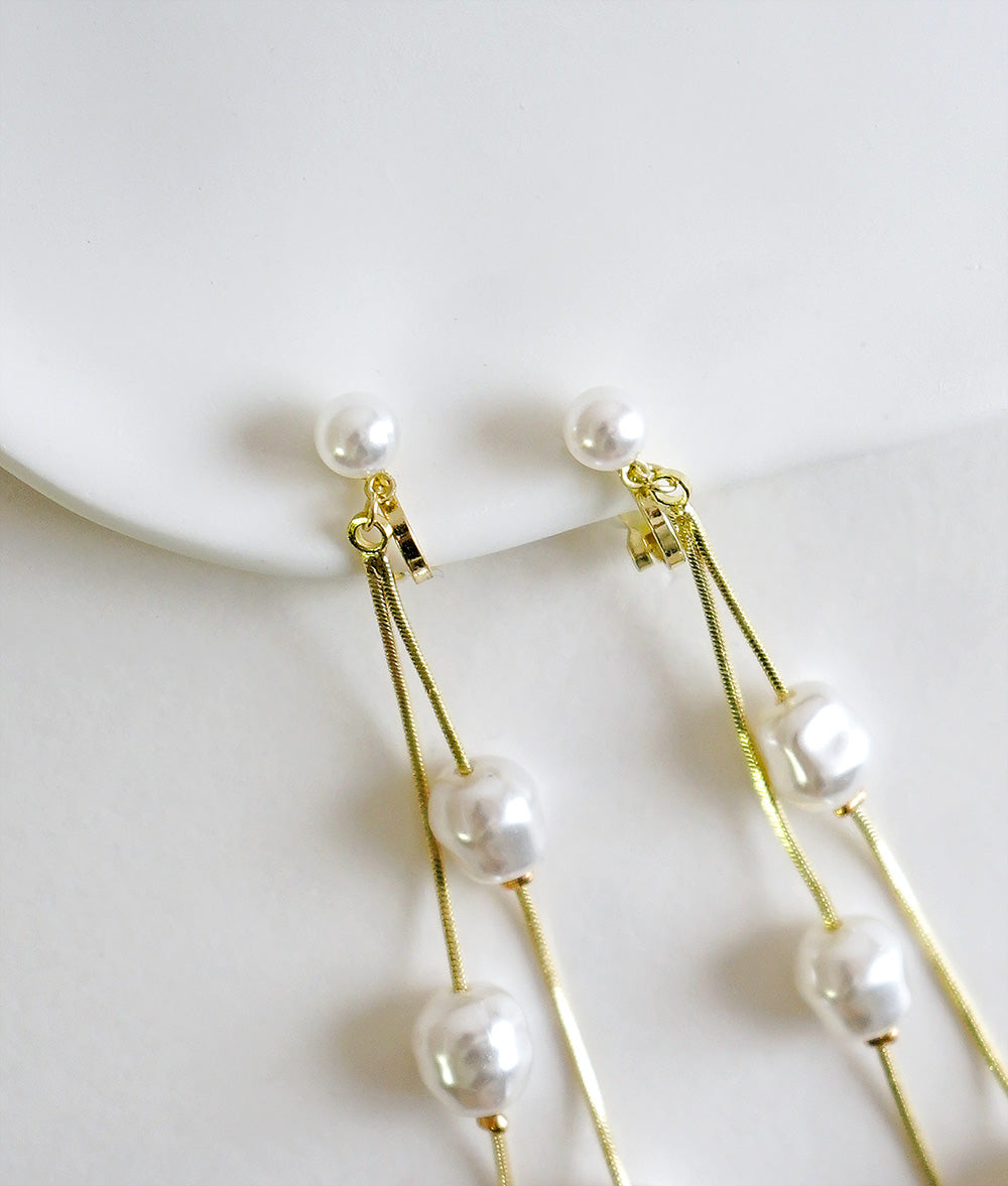 Dangling pearl earrings