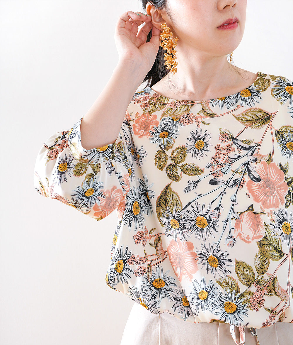 A soft, thick blouse with a simple flower that gently shines