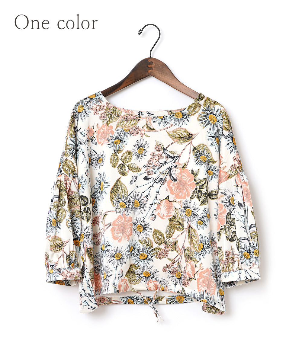A soft, thick blouse with a simple flower that gently shines