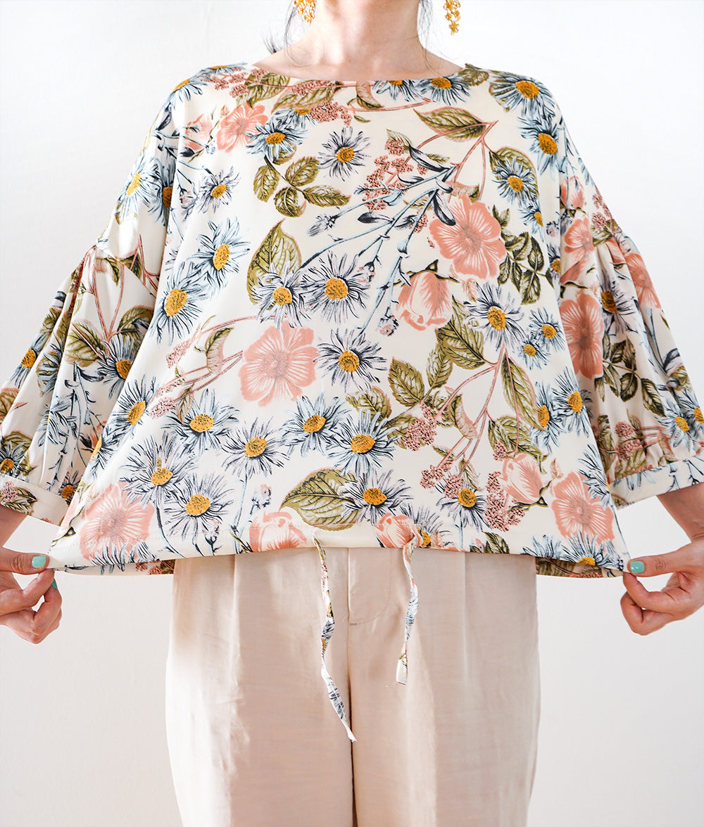 A soft, thick blouse with a simple flower that gently shines