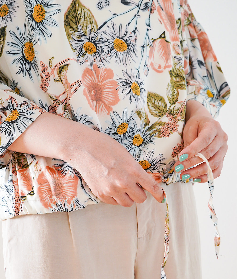 A soft, thick blouse with a simple flower that gently shines