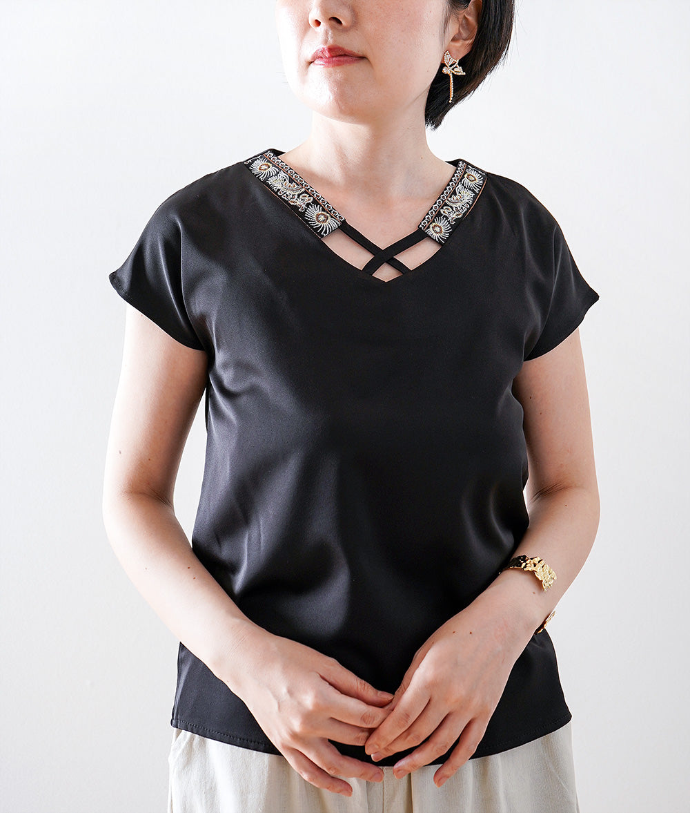 Glossy blouse with embroidery and cross lines