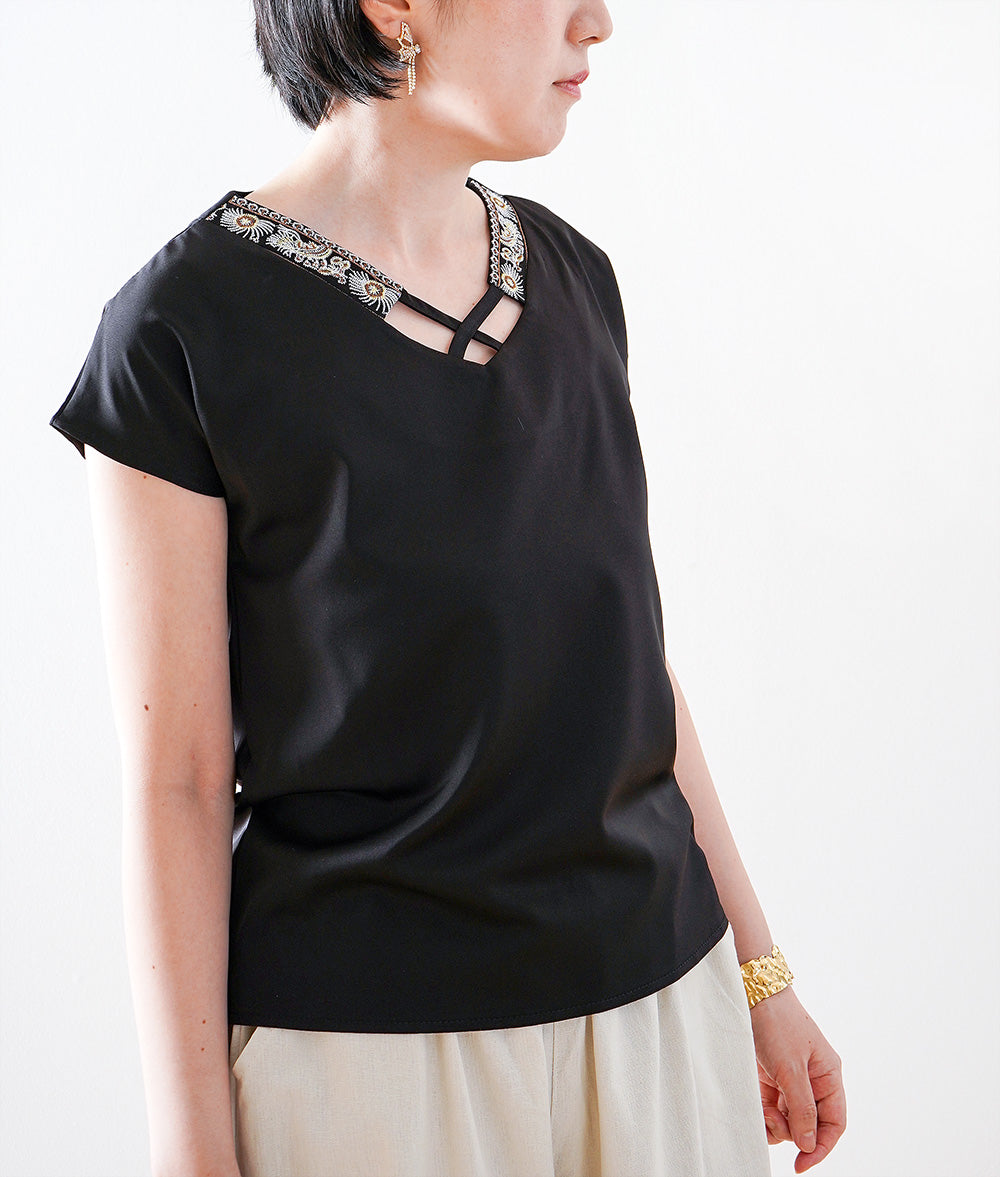 Glossy blouse with embroidery and cross lines