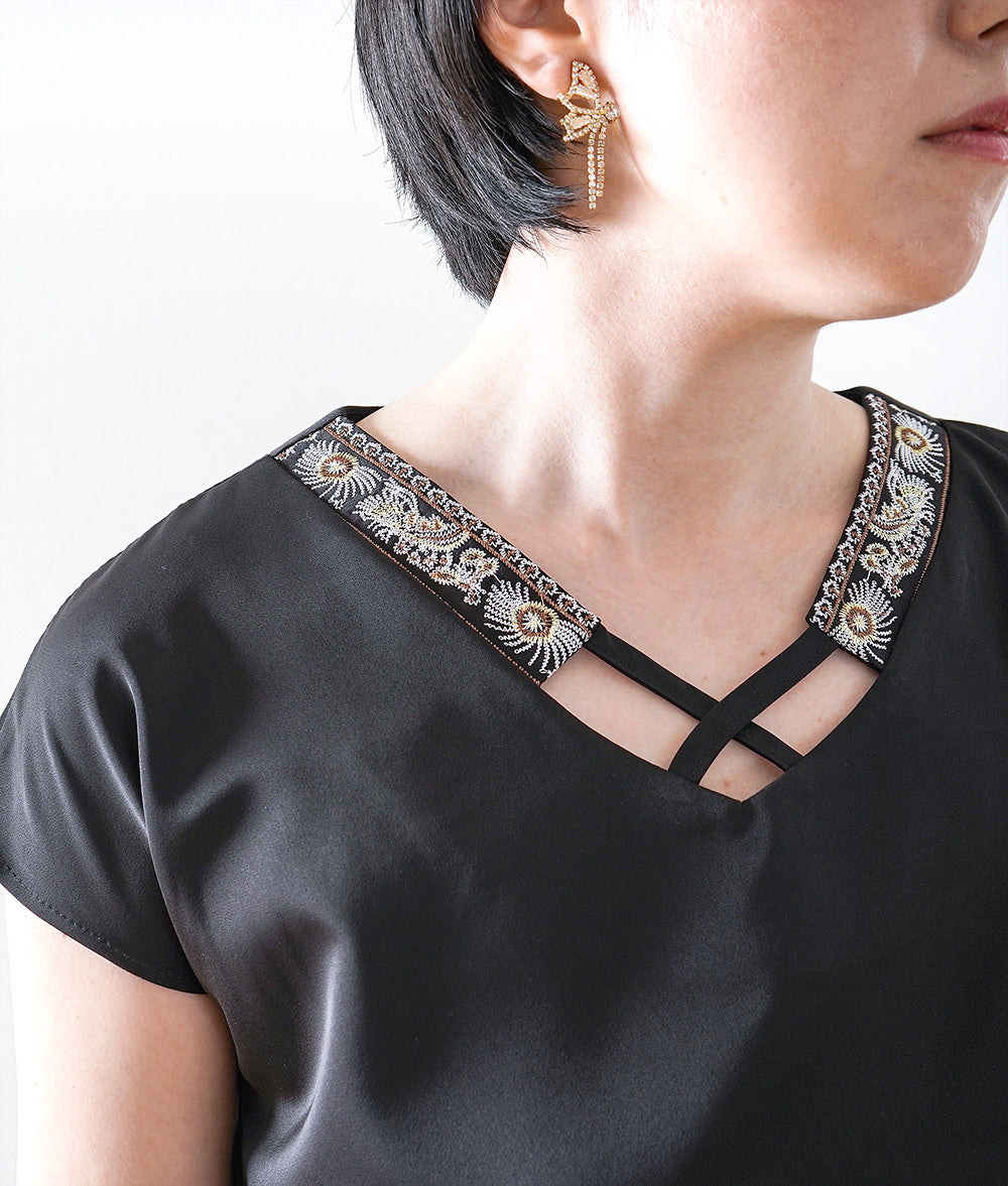 Glossy blouse with embroidery and cross lines