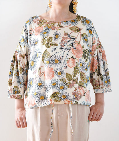A soft, thick blouse with a simple flower that gently shines