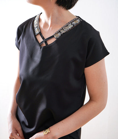 Glossy blouse with embroidery and cross lines